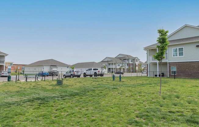 A fenced in dog park with a tree at Crossing at Grove City apartments in Grove City, OH