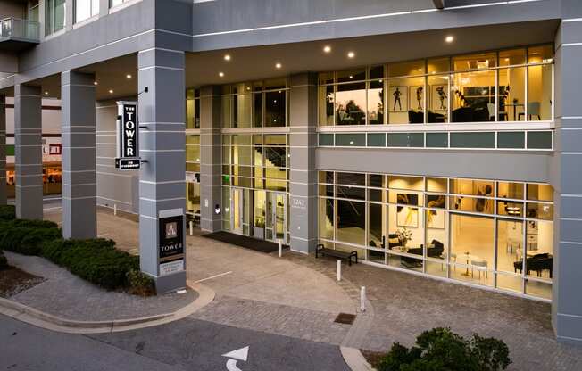 an office building with large glass windows and a courtyard