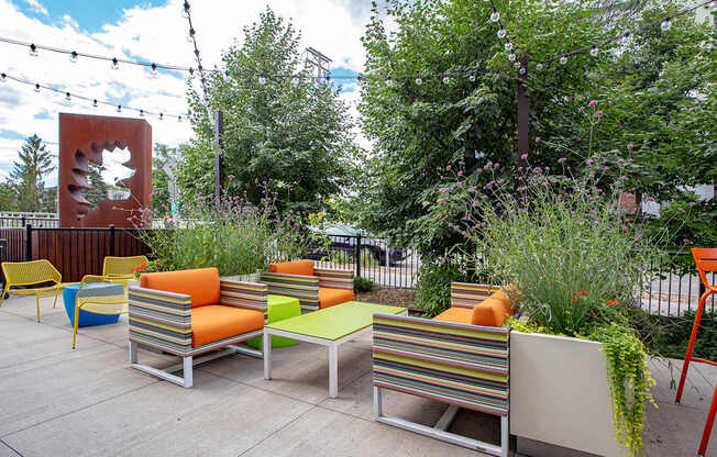 A patio with a bench and a tree.
