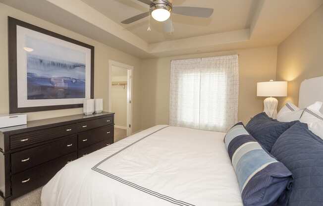 a bedroom with a large bed and a ceiling fan