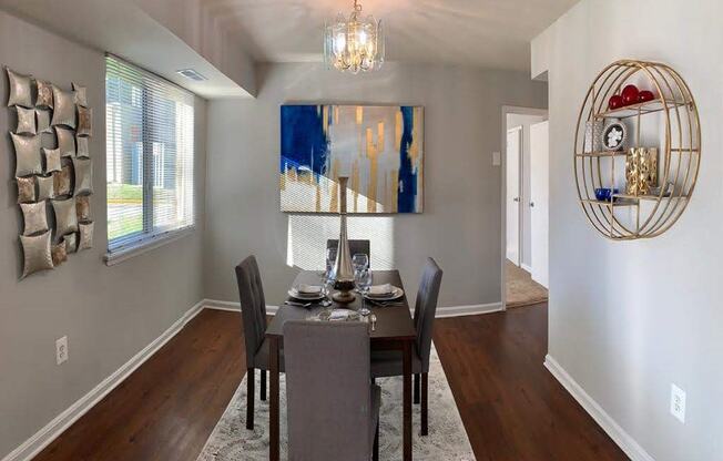 a dining room with a table and chairs at The Glendale Residence, Lanham, 20706