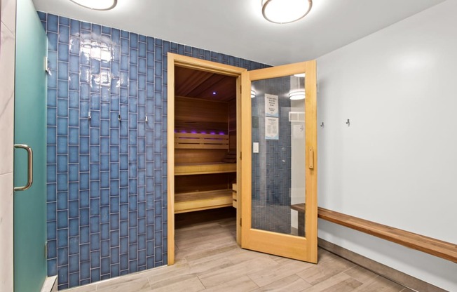 a sauna room with a glass door and a door to a closet