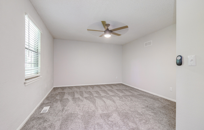 Empty townhome platinum bedroom interior with fresh carpeting at The Arbor in Blue Springs, Missouri