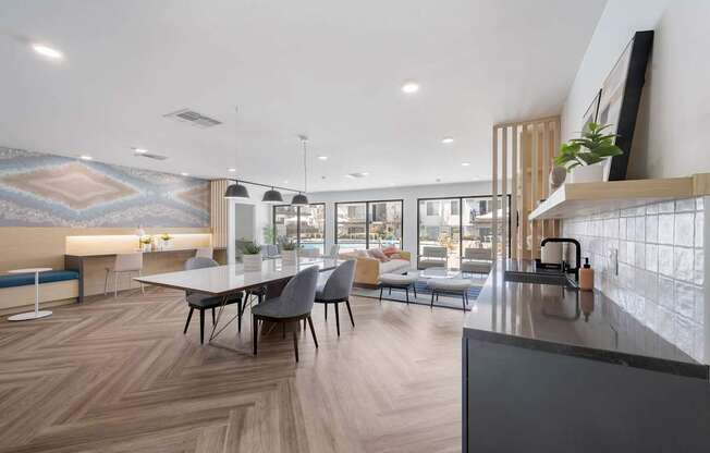 A modern dining area with a long table and chairs.