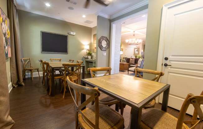 a dining room with tables and chairs and a tv on the wall