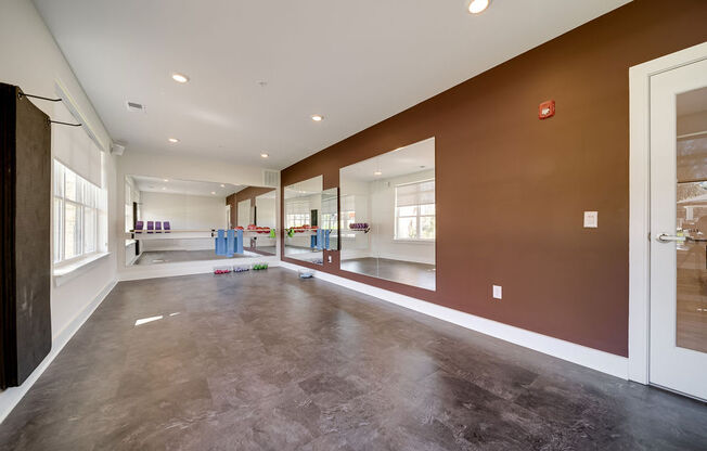 a large empty room with a large window and a door