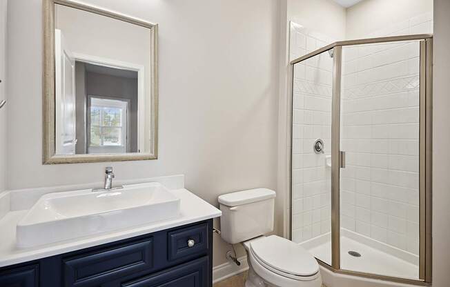 A bathroom with a white sink and a toilet.