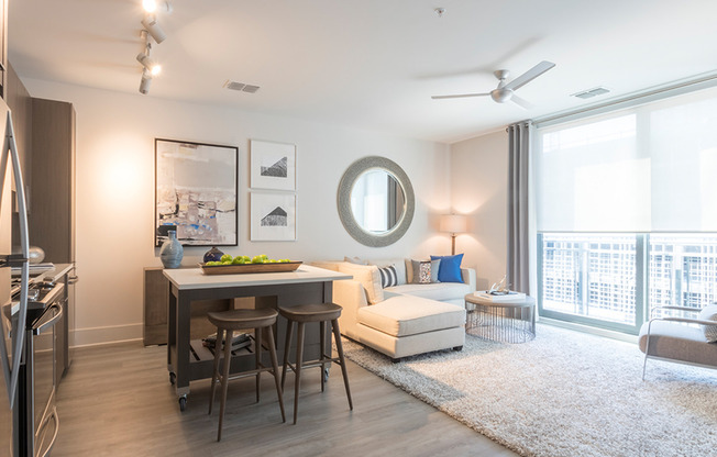 Spacious dining and living area with floor to ceiling windows