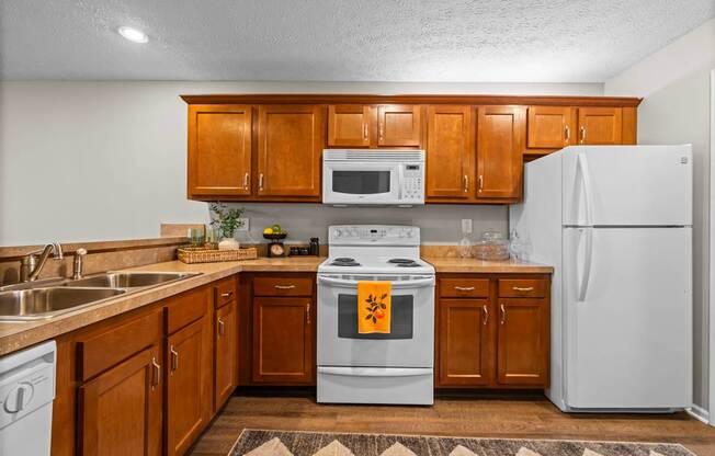 A kitchen with wooden cabinets and a white refrigerator.