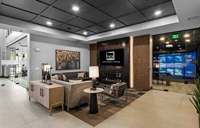 A modern living room with a couch, a chair, and a television.