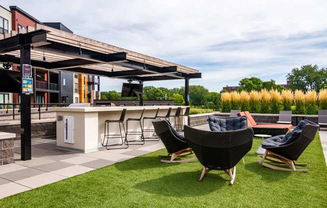 Outdoor entertaining space with a pergola, dining area, and comfortable seating.