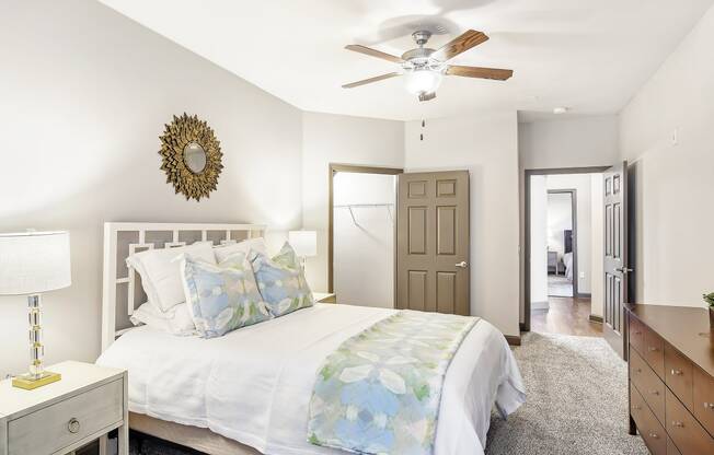 a bedroom with a large bed and a ceiling fan