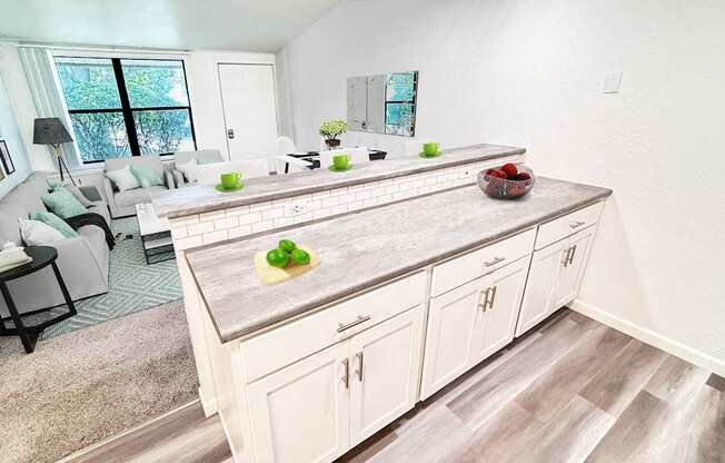 A kitchen with a large island and a dining table with chairs.