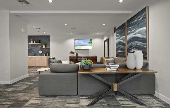 a living room with a gray couch and a wooden table