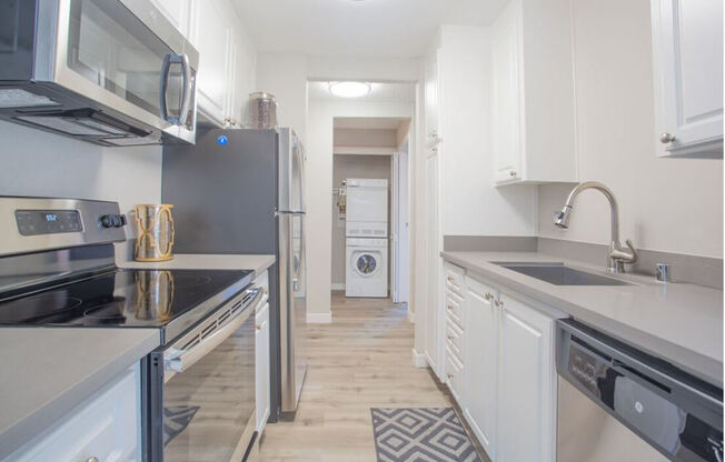 a kitchen with white cabinets and stainless steel appliances at Sunnyvale Crossings Apartments, LLC, Sunnyvale, CA 94087