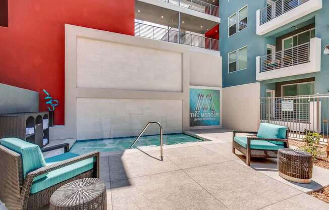 A pool area with a white wall and a sign that says "The Mercer".