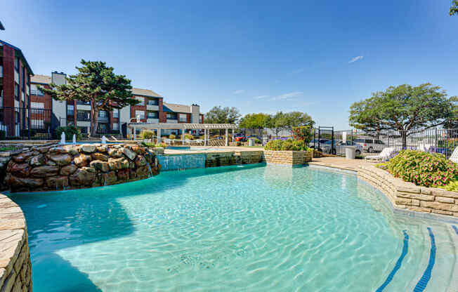 a large pool with a building in the background