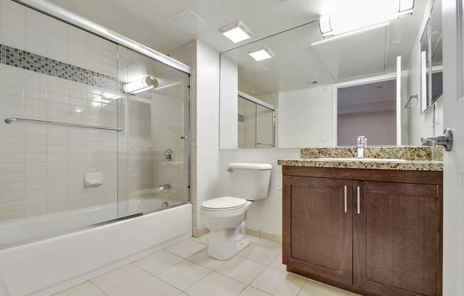 a bathroom with a toilet and a shower and a sink