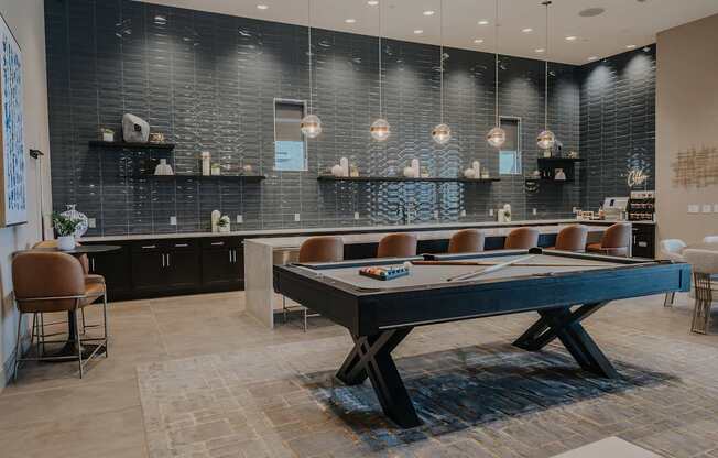 Clubhouse at Level 25 at The Curve with kitchen island, coffee station, and pool table.