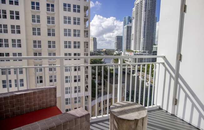 a balcony with a view of the city and a red carpet