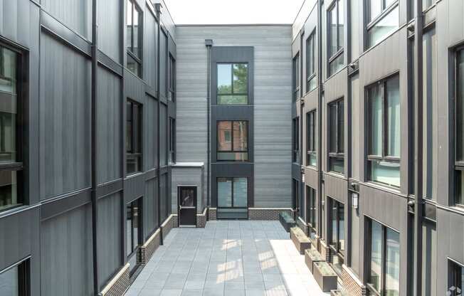 the courtyard of a condo building with a glass door in the middle