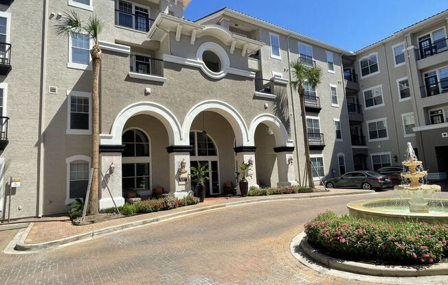 A building with a fountain in front of it.