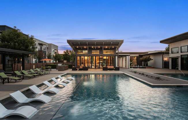 A modern house with a pool in the backyard.