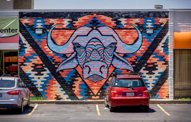 A mural of a bull's head is painted on a wall.