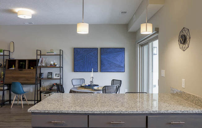 Kitchen peninsula with sophisticated pendant lights at WH Flats new luxury apartments in south Lincoln NE 68516