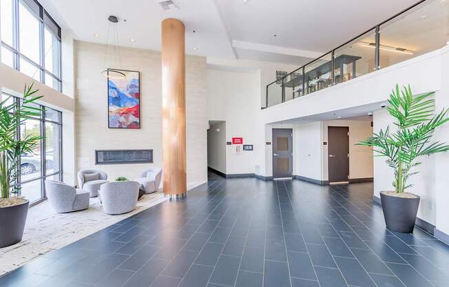 A spacious lobby with a large painting hanging on the wall.