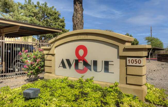 aaque sign at the entrance of a building with a gate