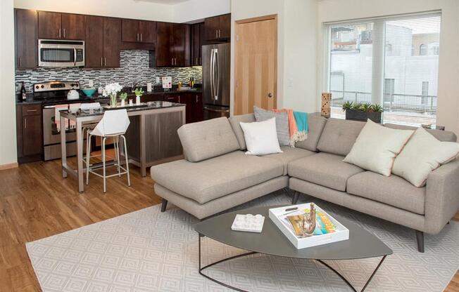 A modern living room with a grey sofa and a coffee table.