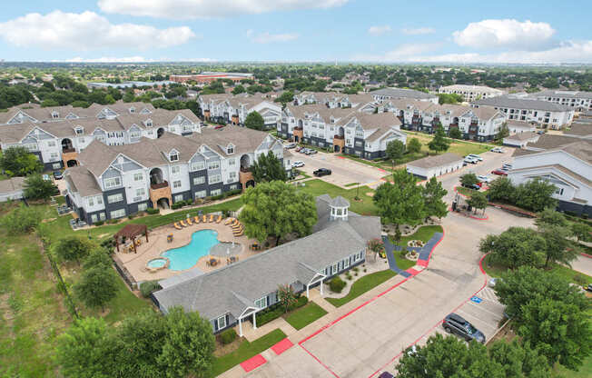 A large residential complex with a swimming pool and playground.