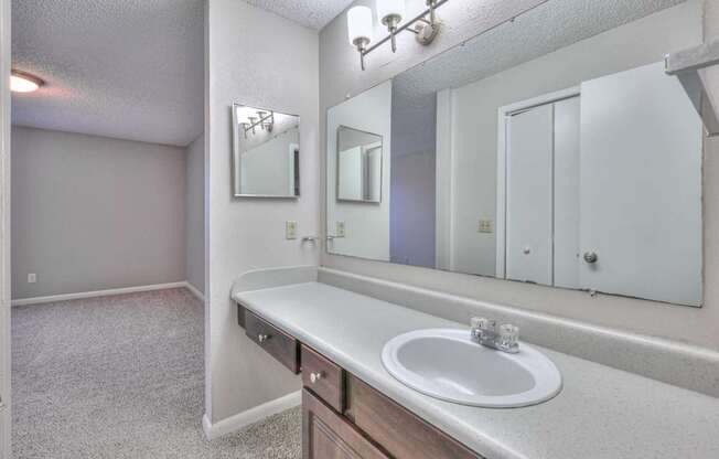 A bathroom with a sink, mirror, and medicine cabinet at Landmark at Lyncrest Reserve Apartments, Tennessee