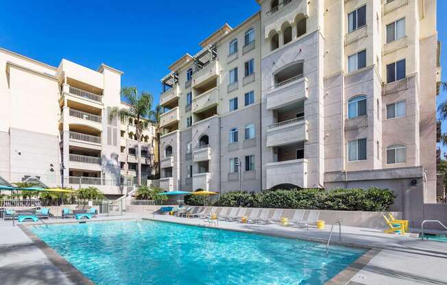 A swimming pool in front of apartment buildings. at La Jolla Crossroads Apartments, San Diego, California