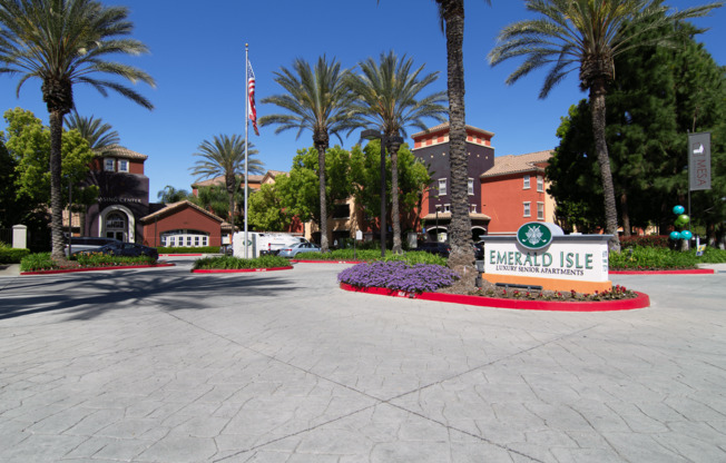 A sign that says Emerald Isle in front of some buildings.,A sign that says Emerald Isle in front of some buildings.