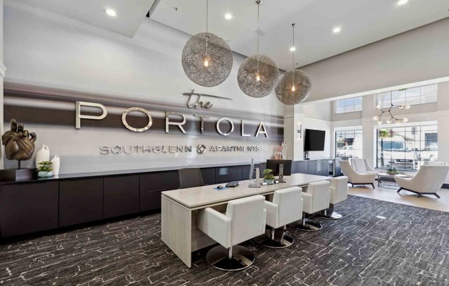 a room with a long table and chairs in front of a sign that says the portola