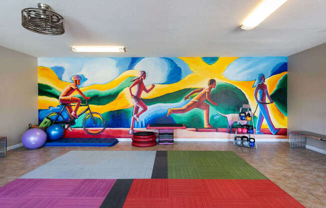 a wall mural in a room with a gym and exercise equipment