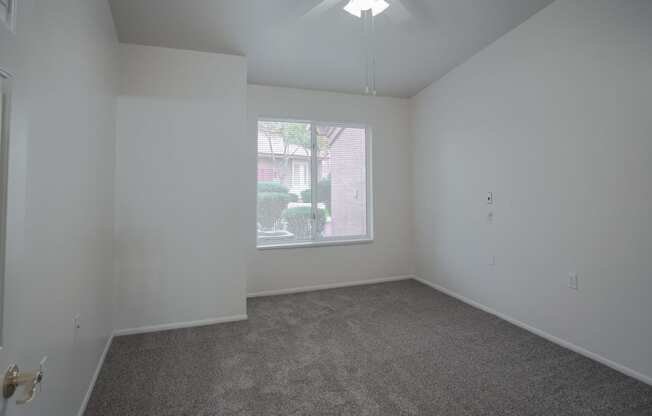 an empty living room with a large window