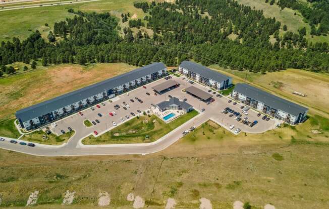 an aerial view of a parking lot and a building