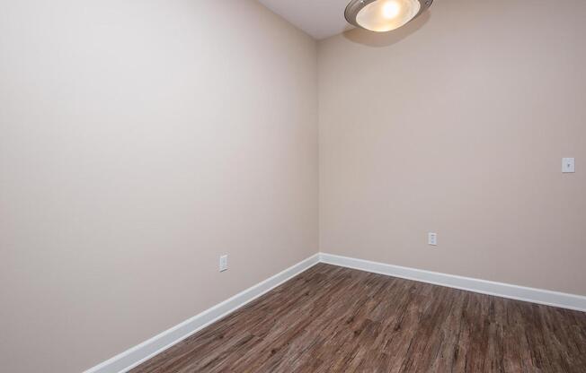 a bedroom with a wooden floor