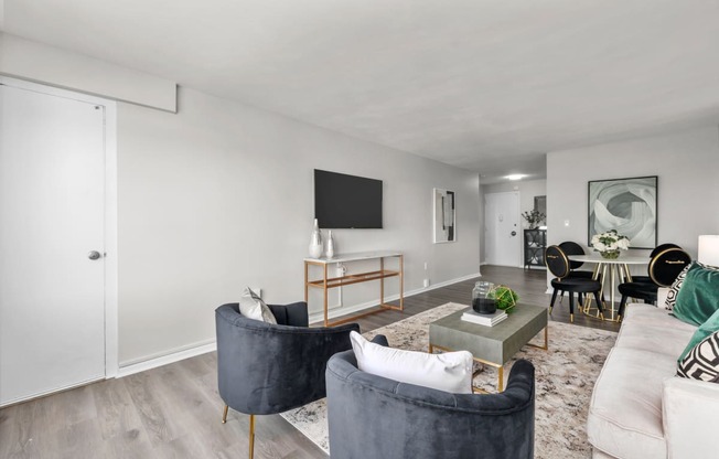 a living room with white walls and hardwood flooring