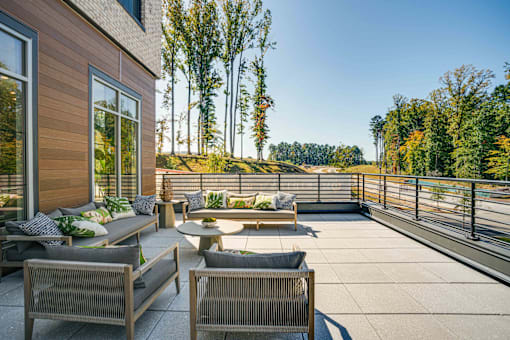 a patio with chairs and tables on a balcony