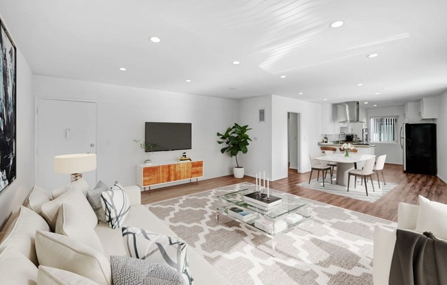 a living room with a white couch and a glass table