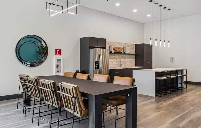 A modern dining room with a long table and chairs.