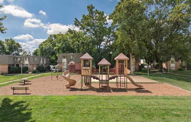 A playground with a slide, swings, and a sandbox.