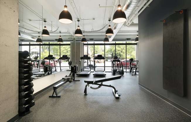 a gym with weights machines and a window