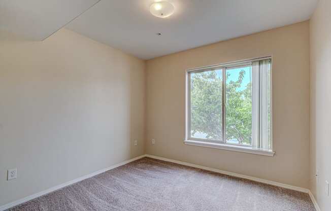 Bedroom with window at River Walk Apartments, Boise
