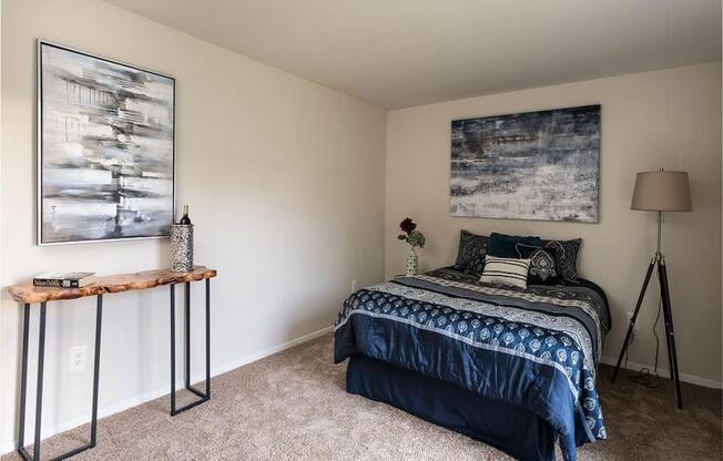 a bedroom with a bed and two paintings on the wall at The Glendale Residence, Lanham, MD, 20706