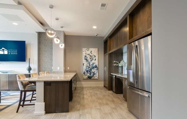 a kitchen and dining room with stainless steel appliances and wood floors